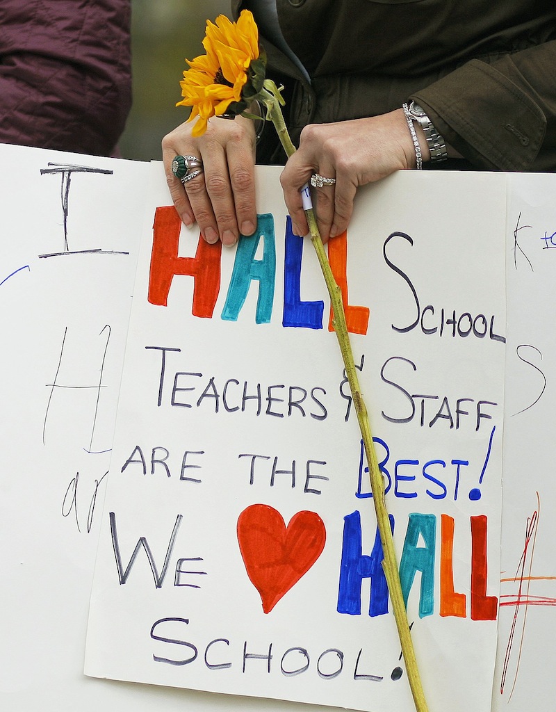 Gloria Noyes, a teacher at the Fred P. Hall Elementary School holds a sign made by one of her students at a rally Thursday, May 2, 2013, held to protest the grade of F given the school by the LePage administration.