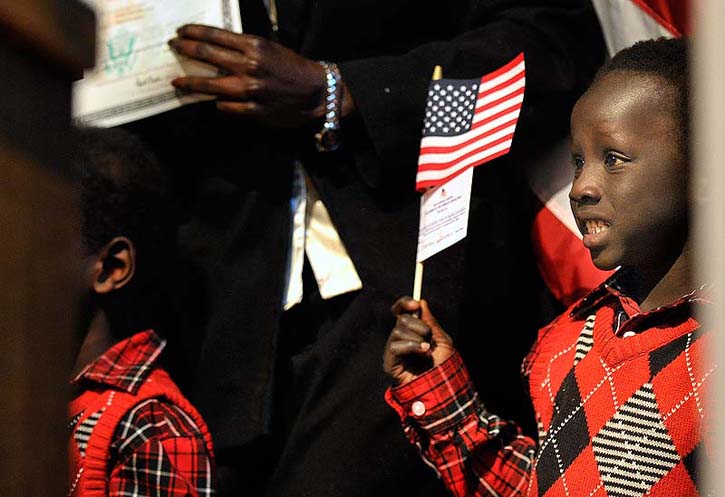 Kandok Ring smiles for a family photo after his mother, Nybol Lual, originally of Sudan, became a U.S. citizen at a naturalization ceremony on Friday at Portland High School.