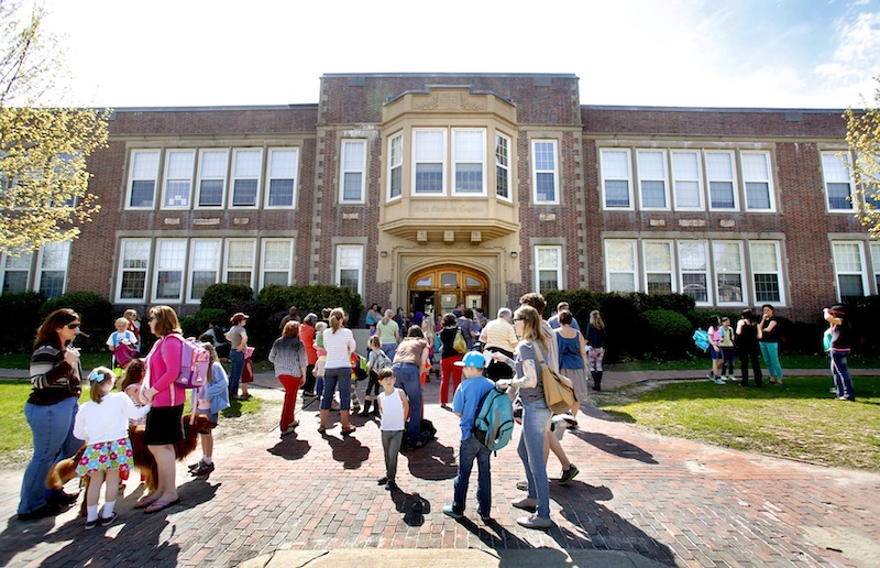 Students exit Longfellow Elementary School at the end of the school day on Friday afternoon in Portland on May 10, 2013. Students file into Hall Elementary School in Portland. The state is promising $30 million to help replace Hall Elementary and fix Longfellow Elementary, according to Portland's finance director.