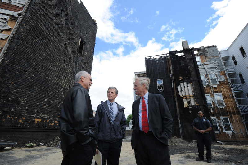 Maine Sen. Angus King tours the fire scenes in Lewiston with Assistant City Administrator Phil Nadeau and Fire Chief Paul LeClair on Friday. In the background are 149 Bartlett St. and the Pierce Street building on the left. King