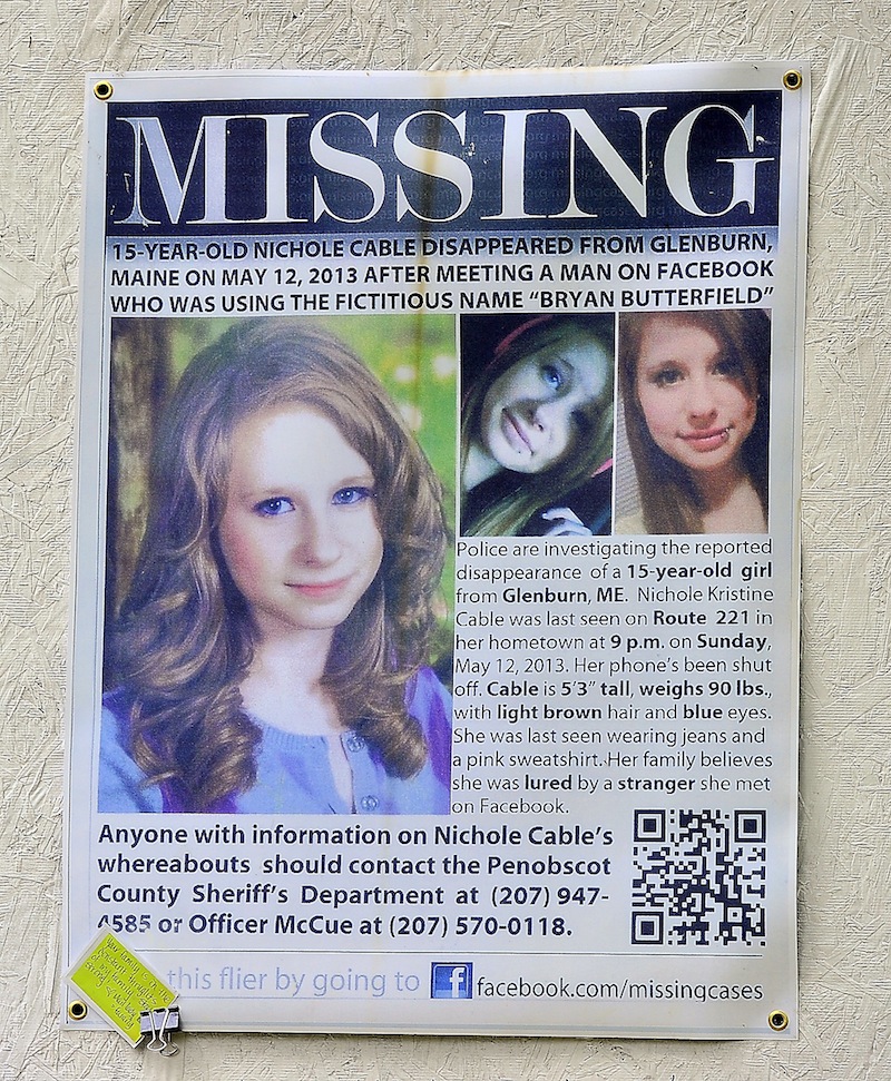 A poster asking for information about the disappearance of Nichole Cable is tacked to a memorial at the corner of her family's driveway and Route 221 in Glenburn on Tuesday, May 21, 2013. Cable's body was found Monday night in a wooded area in Old Town, and a 20-year-old Orono man has been charged with her murder.