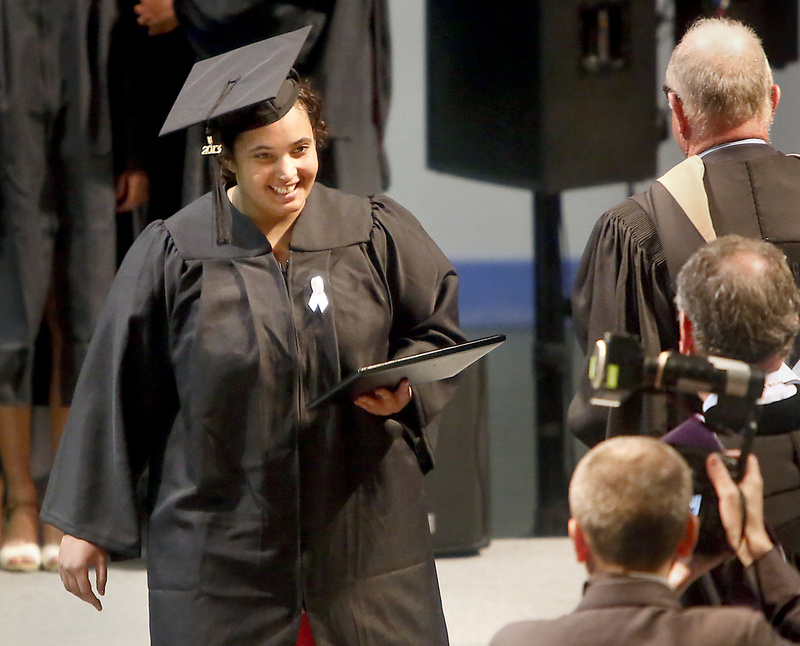 Felicity Hills, who earned her degree in mathematics and physics, walks across the stage with her diploma during the Bowdoin College Commencement Saturday.