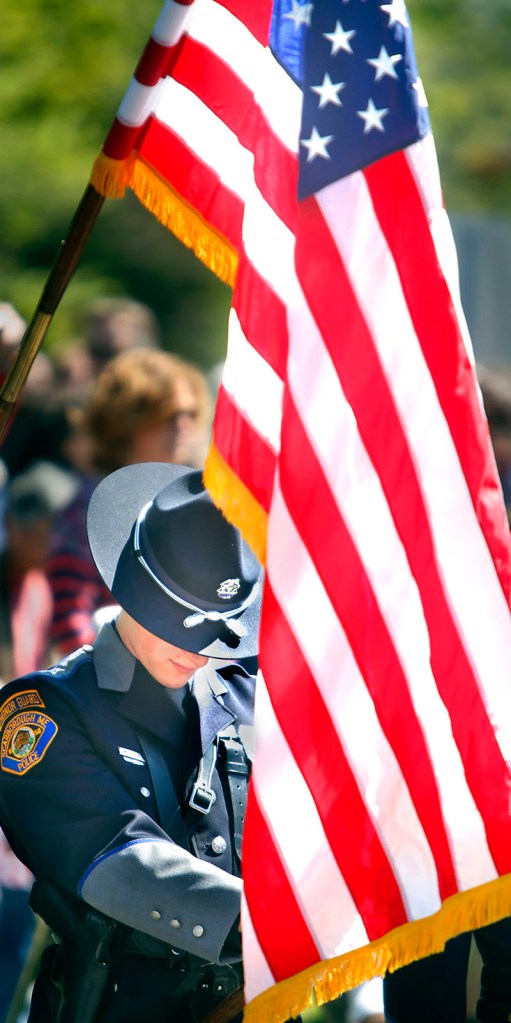 Michael Thurlow, a member of the Scarborough Police Department Honor Guard, bows his head during a prayer for the veterans and current service members during the Scarborough Memorial Day ceremony at the Maine Veterans' Home Monday morning.