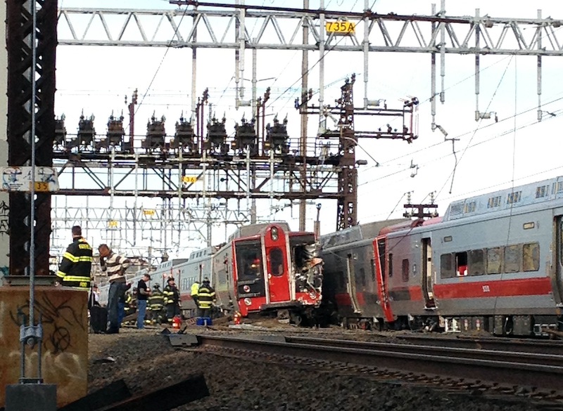 Emergency workers arrive at the scene of a train collision Friday in Fairfield, Conn. The railroad said a train derailed and was hit by the second train.