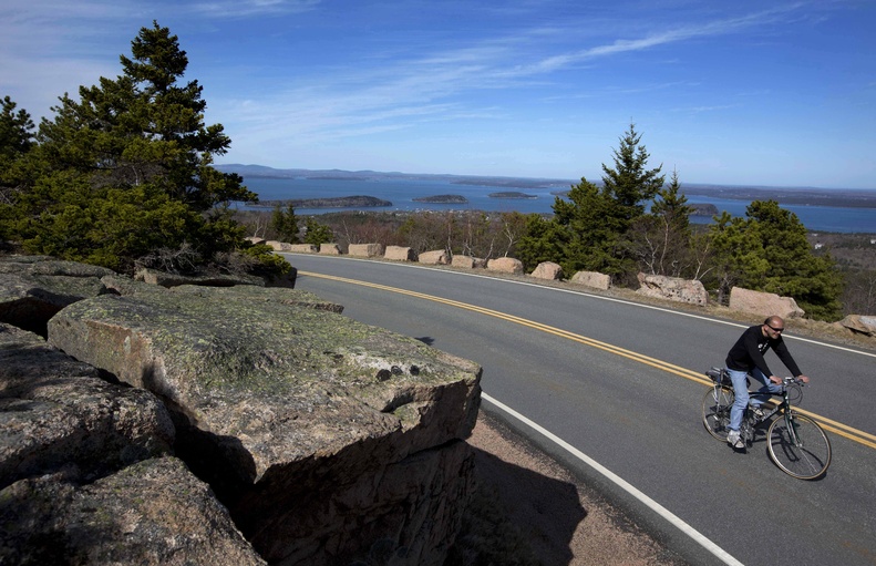 A bicyclists peddles up the road to the summit of Cadillac Mountain on Thursday at Acadia National Park.