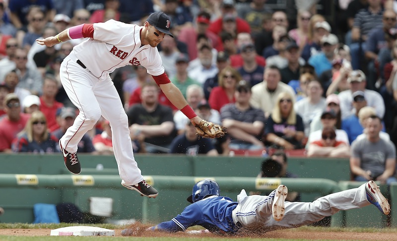 Boston Red Sox third baseman Will Middlebrooks comes down from getting a high throw too late to tag Toronto Blue Jays' Emilio Bonifacio stealing third in the sixth inning Sunday.