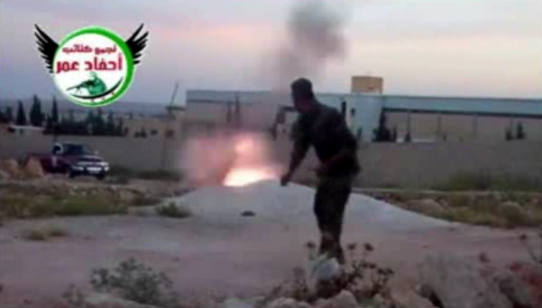 This image from amateur video, which is consistent with AP reporting, shows a rebel fighter firing a mortar with the help of a drawstring in Aleppo, Syria, on Tuesday.