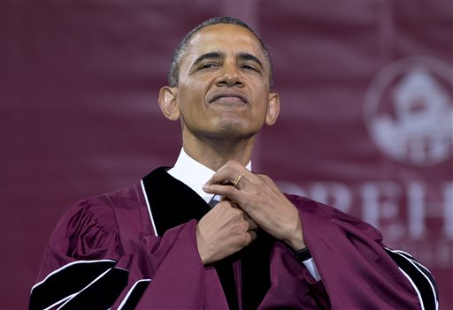 President Obama straightens his tie before he receives an honorary doctorate of laws degree during the Morehouse College commencement ceremony Sunday in Atlanta.