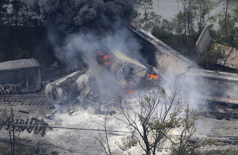 A fire burns at the site of a CSX freight train derailment Tuesday in White Marsh, Md., where fire officials say the train crashed into a trash truck, causing an explosion that rattled homes at least a half-mile away.
