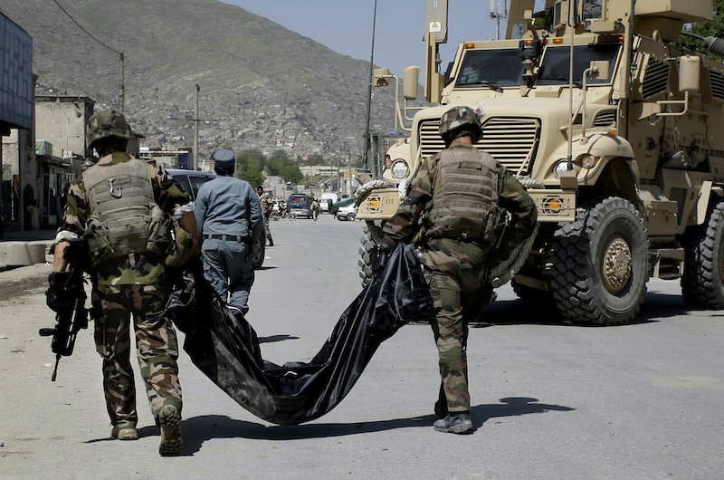 French soldiers with the NATO-led International Security Assistance Force, ISAF, carry the body of a victim killed from a suicide car bomber who attacked a NATO convoy in Kabul, Afghanistan, Thursday, May 16, 2013. A Muslim militant group, Hizb-e-Islami, claimed responsibility for the early morning attack, killing many in the explosion and wounding tens, police and hospital officials said. The powerful explosion rattled buildings on the other side of Kabul and sent a pillar of white smoke into the sky in the city's east. (AP Photo/Ahmad Nazar)