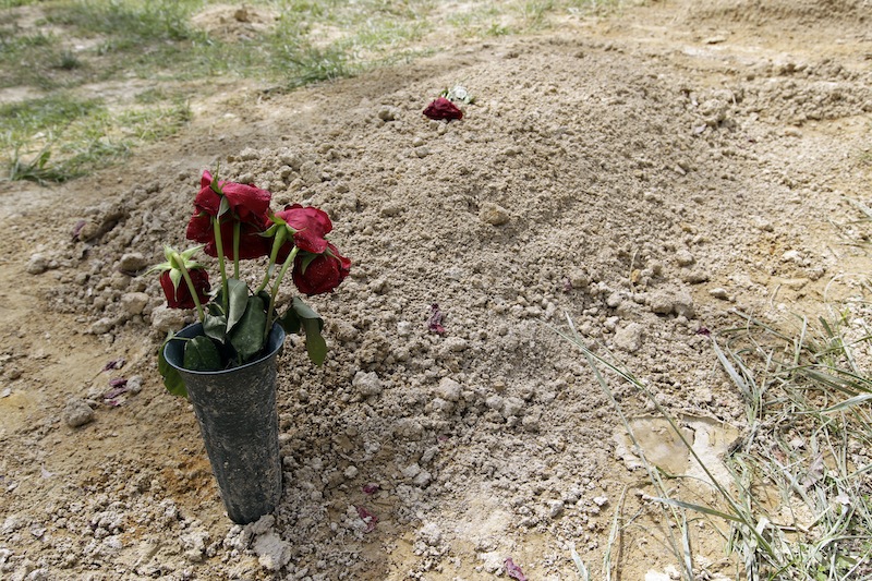 Flowers are placed on the alleged burial site of Boston Marathon bombing suspect Tamerlan Tsarnaev in Doswell, Va., Friday, May 10, 2013. Tsarnaev's uncle Ruslan Tsarni said Tsarnaev was buried in the cemetery in Doswell, near RichmondVa. Tsarnaev was killed April 19 in a getaway attempt after a gunbattle with police. His younger brother, Dzhokhar, was captured later and remains in custody. (AP Photo/Luis M. Alvarez)