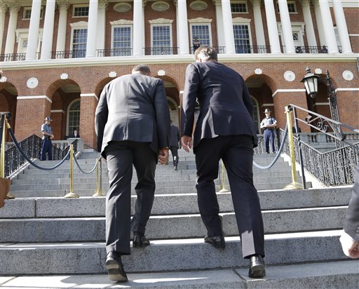 Mass. Gov. Deval Patrick, left, accompanies British Prime Minister David Cameron up the steps into the Massachusetts Statehouse in Boston on Monday.