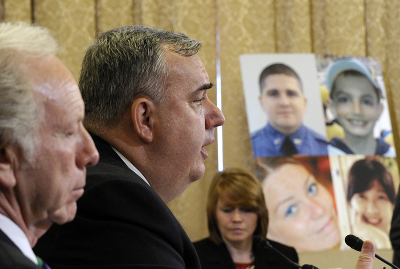 Boston Police Commissioner Edward Davis testifies before the House Homeland Security Committee at a hearing on the Boston Marathon bombings in Washington on Thursday. Former Sen. Joseph Lieberman, I-Conn., sits at left, and photos of those who were killed in the bombings are at right.