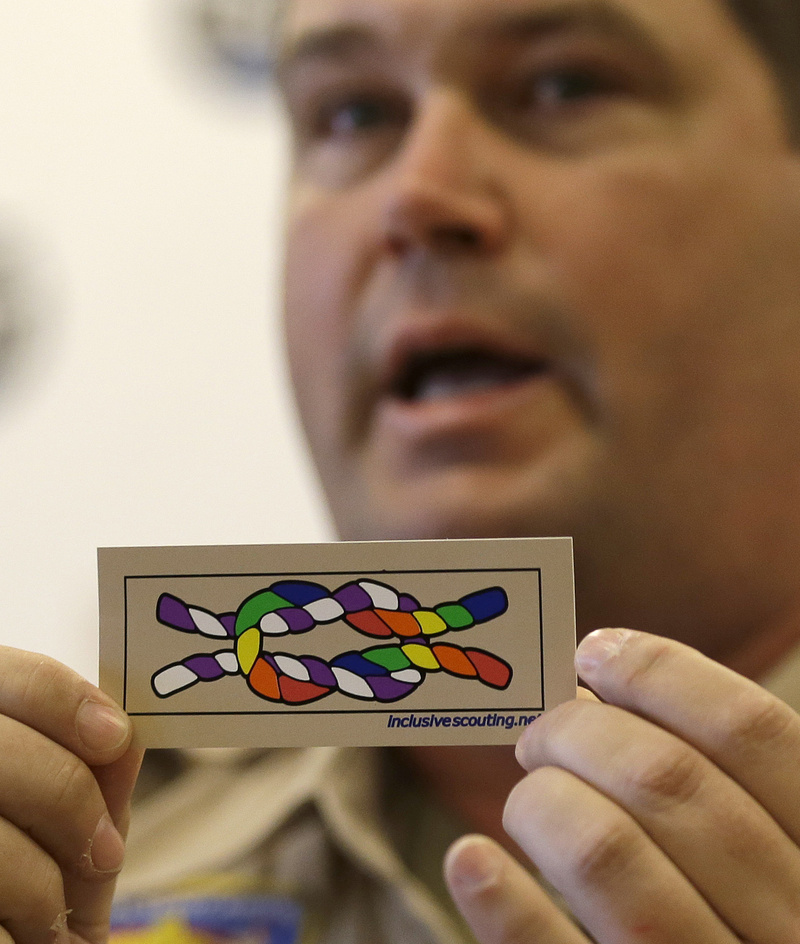 Former scout maser Mark Noel, of Hanover, N.H., holds up a new merit badge of inclusion during a news conference at the Equal Scouting Summit being held near where the Boy Scouts of America were holding their annual meeting Wednesday in Grapevine, Texas.