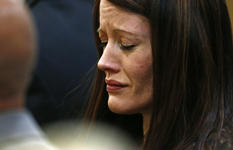 Tanisha Sorenso closes her eyes as autopsy photos of her brother Travis Alexander are displayed on Wednesday during the sentencing phase of the Jodi Arias murder trial at Maricopa County Superior Court in Phoenix.