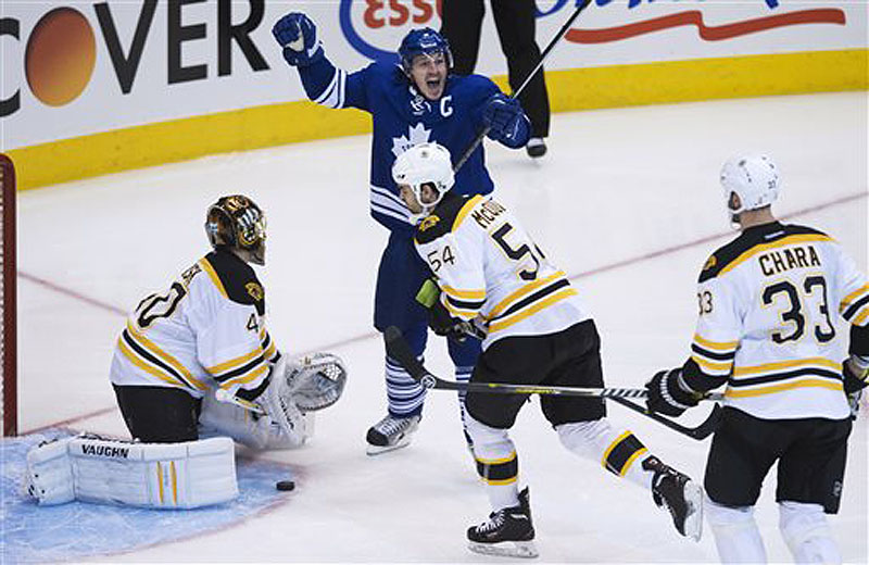 Toronto's Dion Phaneuf reacts after getting the puck past Boston Bruins goalie Tuuka Rask in the third period Sunday in Toronto.
