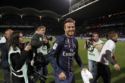 Paris Saint-Germain's David Beckham celebrates his team's victory in a French League One soccer match against Lyon, in Lyon, France, on Sunday.