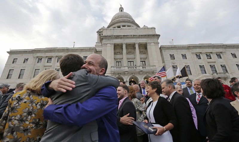 Two men embrace after a gay marriage bill was signed into law outside the State House in Providence, R.I., Thursday, May 2, 2013. (AP Photo/Charles Krupa)