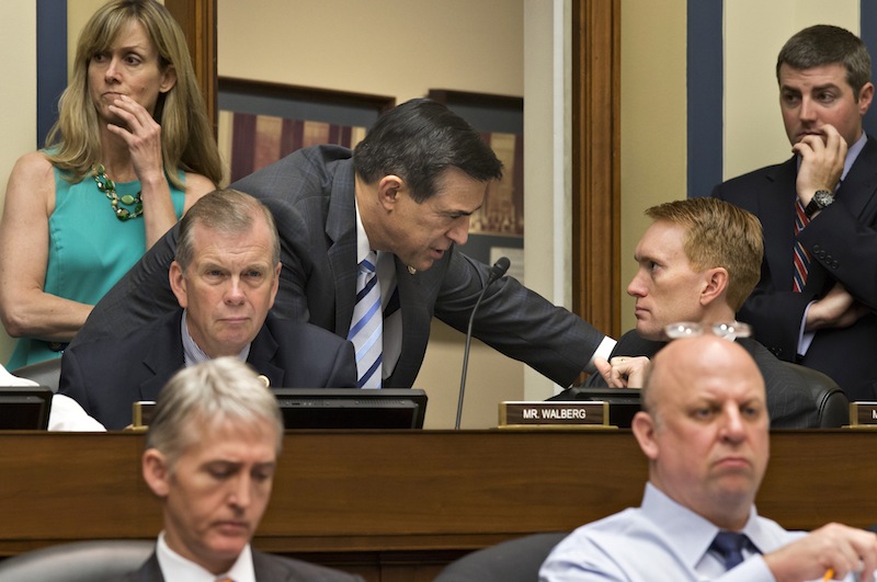 House Oversight and Government Reform Committee Chairman Rep. Darrell Issa, R-Calif., center, leans over to speak with Rep. James Lankford, R-Okla., on Capitol Hill in Washington, Wednesday, May 22, 2013, during the committee's hearing to investigate the extra scrutiny the Internal Revenue Service gave Tea Party and other conservative groups that applied for tax-exempt status. Rep. Scott DesJarlais, R-Tenn., is at lower right, and Rep. Trey Gowdy, R-SC, is at lower left. Rep. Tim Walberg, R-Mich., listens at center left. (AP Photo/J. Scott Applewhite)