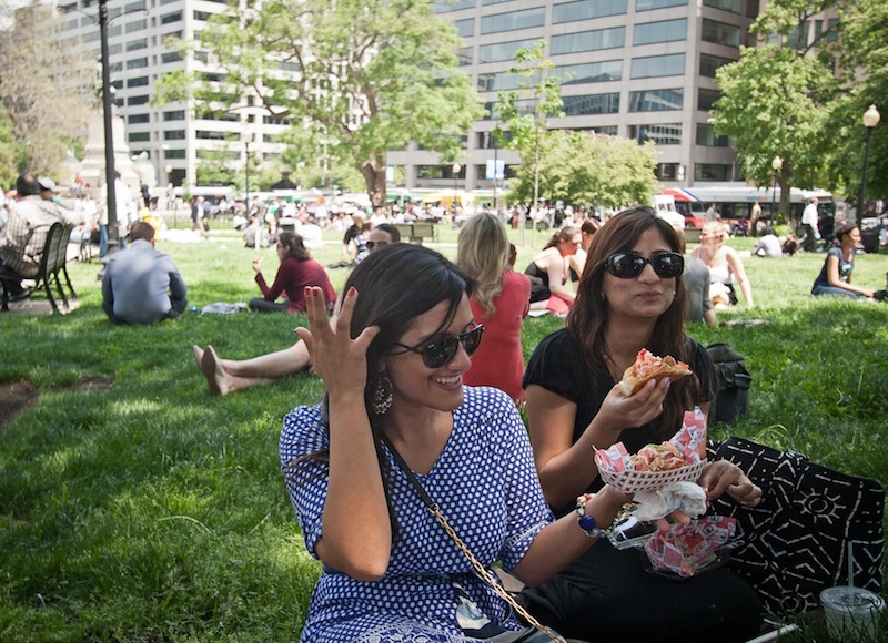 Roxanne Namazi, left, and Hiba Anwar, enjoyed their first lobster rolls from The Red Hook Lobster Pound DC food truck as they sat in the shade at Farragut Square in Washington DC on Friday, May 10, 2013. food truck; DC; washington; Maine; lobster; new england; seafood