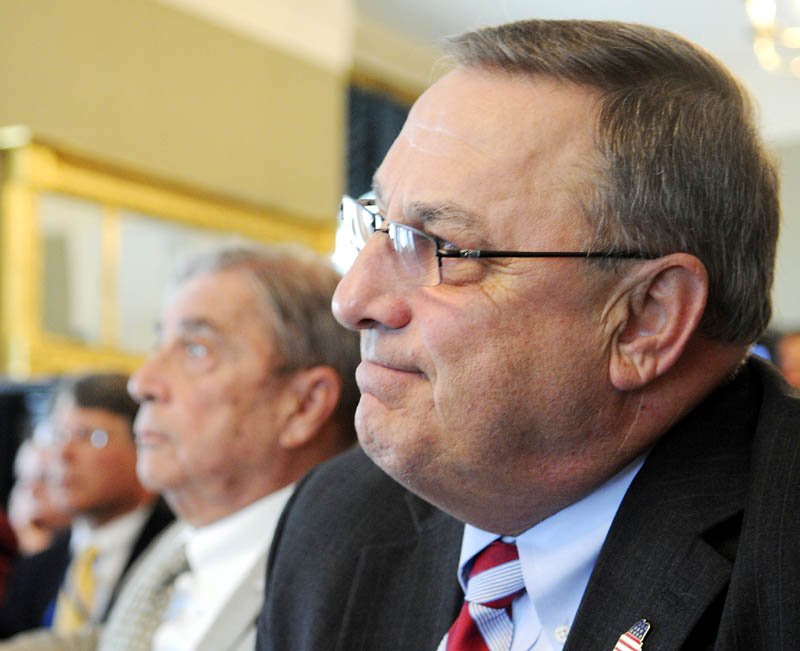 Gov. Paul LePage listens to demographic data Monday at the Blaine House.