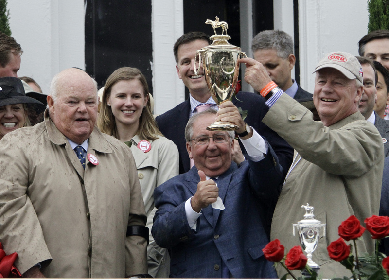 Orb trainer Claude McGaughey, center, is flanked by owners Ogden Phipps, left, and Stuart Janney after winning the 139th Kentucky Derby at Churchill Downs on May 4 in Louisville, Ky.