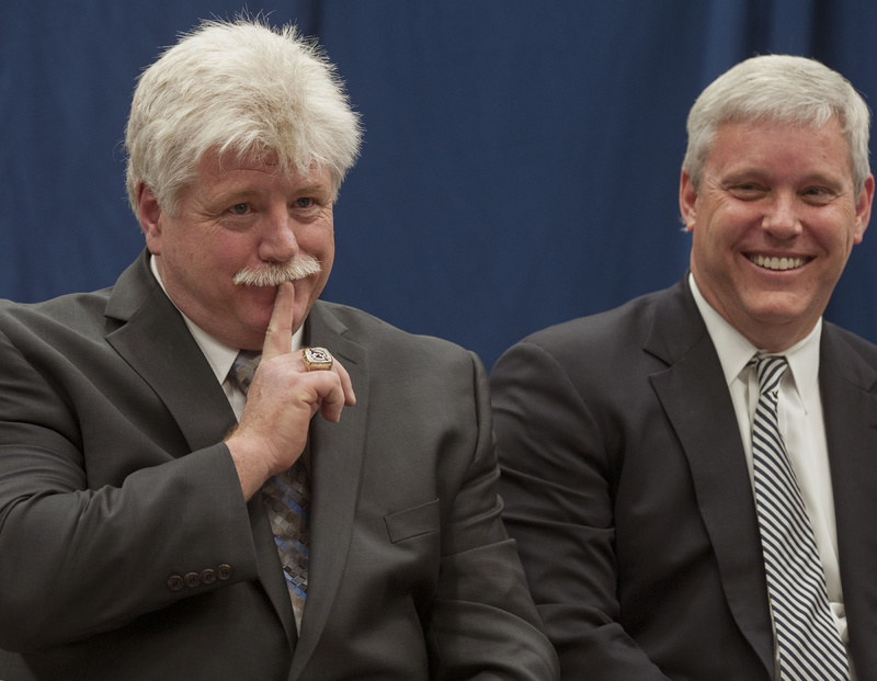 Dennis "Red" Gendron, left, gestures animatedly during a news conference Tuesday at the University of Maine in Orono where he was introduced as the new men's hockey coach by Athletic Director Steve Abbott, right.