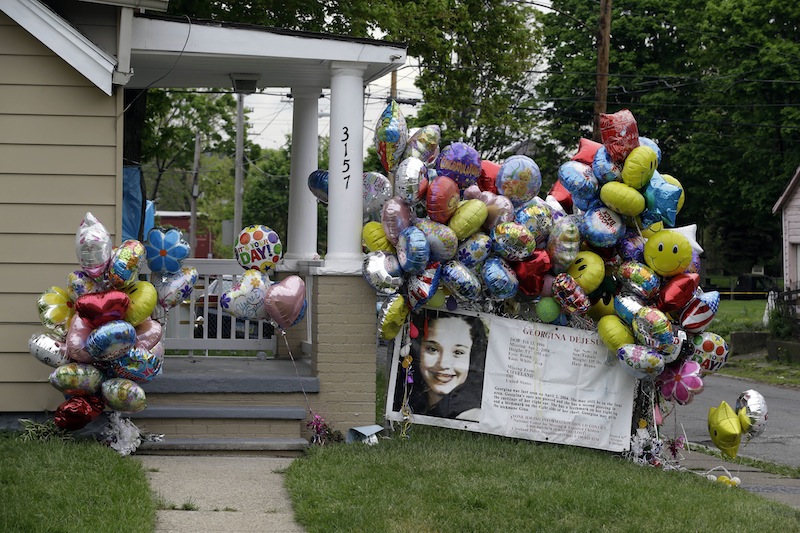 Balloons surround the porch at the home of Gina DeJesus in Cleveland Friday, May 10, 2013. DeJesus was freed Monday from the home of Ariel Castro where she and two other women had been held captive for nearly a decade. (AP Photo/Mark Duncan)