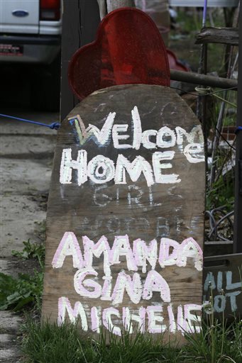 A sign responding to the return of three women held captive for years rests in front of a home Saturday in Cleveland.
