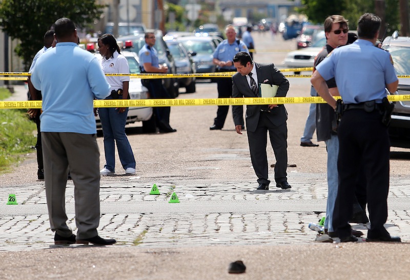 New Orleans police officers investigate the scene at the Frenchmen and N. Villere streets in New Orleans after gunfire at a Mother's Day second-line parade on Sunday. Police spokeswoman Remi Braden said in an email that many of the 19 victims were grazed and most of the wounds weren't life-threatening. No deaths were reported.