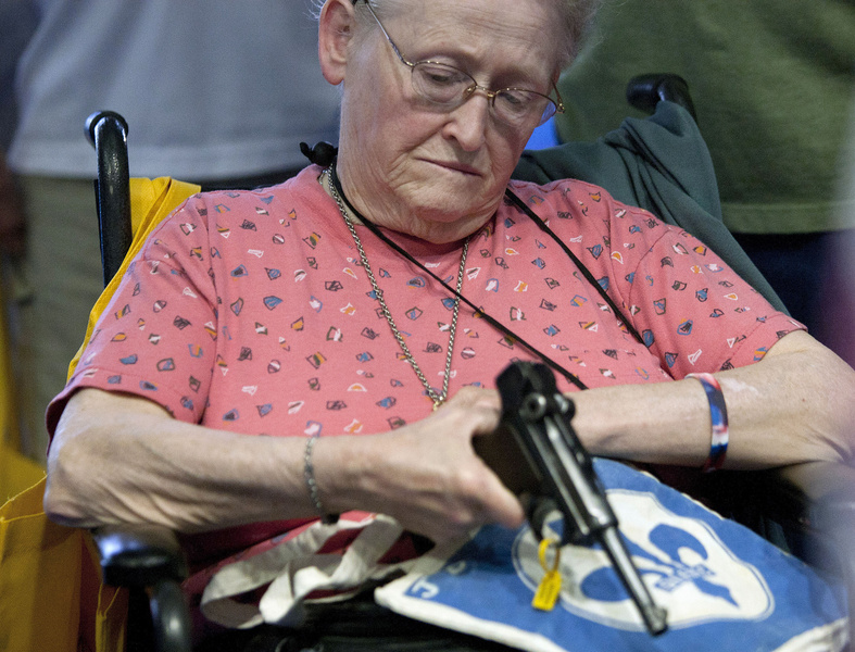 Janet Bero waits to have her German Luger appraised during the National Rifle Association's annual meeting Thursday in Houston. NRA national Rifle Association set up 142 Annual Meetings and Ex
