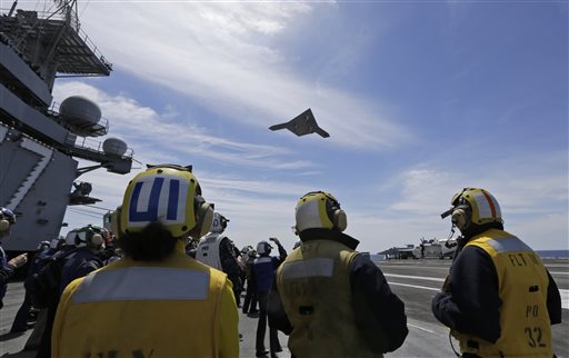A Navy X-47B drone does a fly-by over the USS George H. W. Bush after it was launched from the carrier off the coast of Virginia on Tuesday.