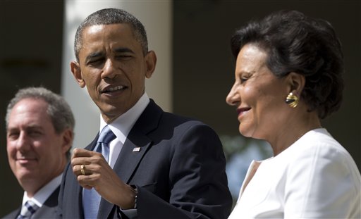 President Barack Obama looks to longtime fundraiser and philanthropist Penny Pritzker, right, in the Rose Garden of the White House on Thursday, where he announced that he will nominate Pritzker to run the Commerce Department and economic adviser Michael Froman, left, as the next U.S. Trade Representative.