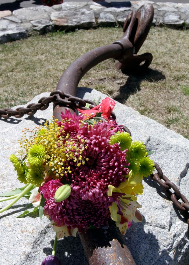 Flowers are seen on one of the turnbuckles that once held the Old Man of the Mountain together Friday, May 3, 2013 in Franconia, N.H. during a ceremony for the 10th anniversary of the date the natural rock formation and state emblem crashed to the ground.(AP Photo/Jim Cole)