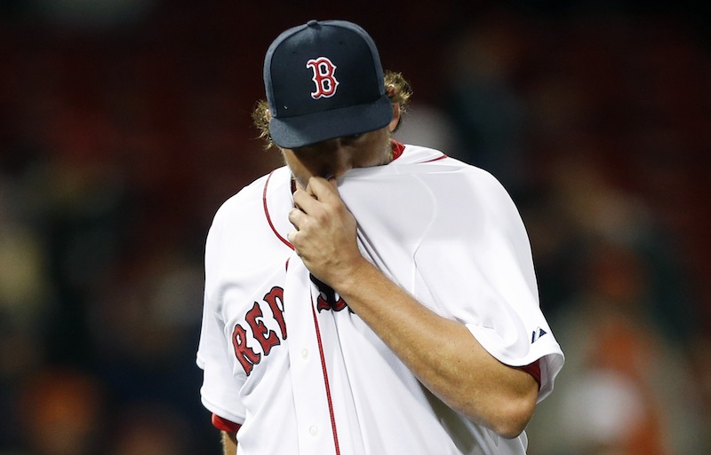 Boston Red Sox closer Joel Hanrahan wipes his face after being taken out after giving up 5 runs to the Baltimore Orioles in the ninth inning of a baseball game, Wednesday, April 10, 2013, in Boston.