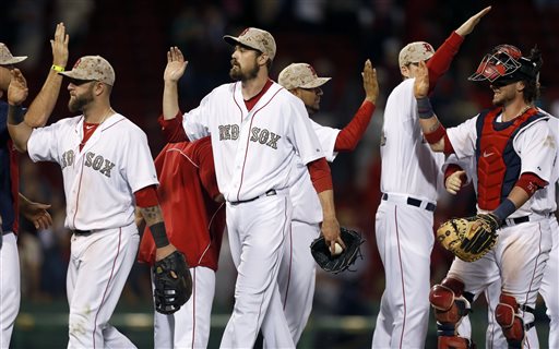 Boston Red Sox's Mike Napoli, left, Andrew Miller, center, and Jarrod Saltalamacchia, right, celebrate after defeating the Philadelphia Phillies 9-3 Monday in Boston.