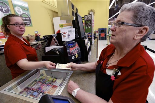 Sharon Brickey, right, purchases a Powerball ticket from Tiffany Enders, left, at a Baker's supermarket in Omaha, Neb., on Wednesday. Enders recently sold a million dollar Powerball ticket at the store.