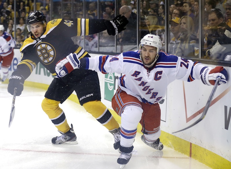 In this file photo, Boston Bruins defenseman Matt Bartkowski (43) and New York Rangers right wing Ryan Callahan (24) grapple along the boards during Game 2 of the NHL Eastern Conference semifinal playoffs. Bartowski, a Pittsburgh native, will try to help the Bruins knockoff his hometown team and advance to the Stanley Cup Finals. (AP Photo/Elise Amendola) TD Garden