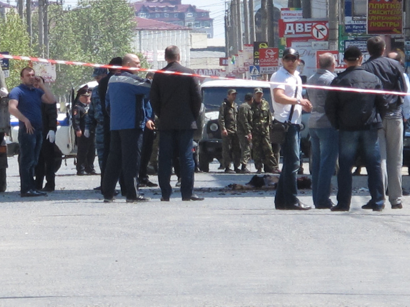 Police and forensic experts examine the site of an explosion in downtown Makhachkala, Dagestan on Wednesday. Russian police say a bomb exploded in a busy shopping area in the capital of the restive republic of Dagestan, killing at least two people. Dagestan is plagued by Islamic insurgents who frequently mount small attacks on police.