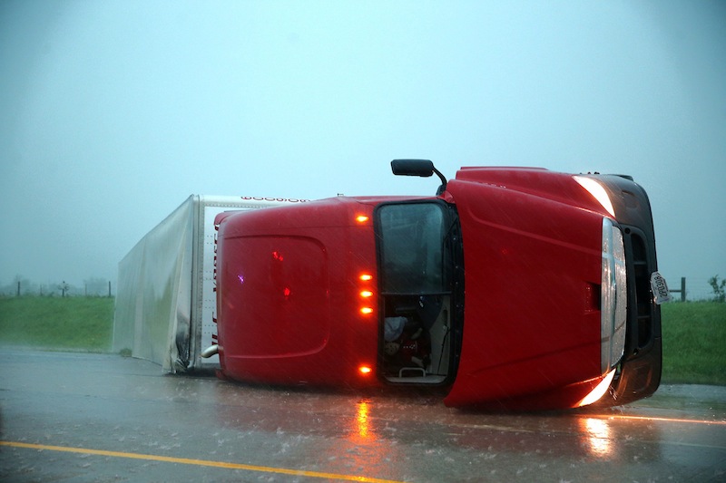 An overturned semitrailer rests on its side on the eastbound lanes of Interstate 40, just east of El Reno, Okla., after a reported tornado touched down, Friday, May 31, 2013. (AP Photo/The Omaha World-Herald, Chris Machian)