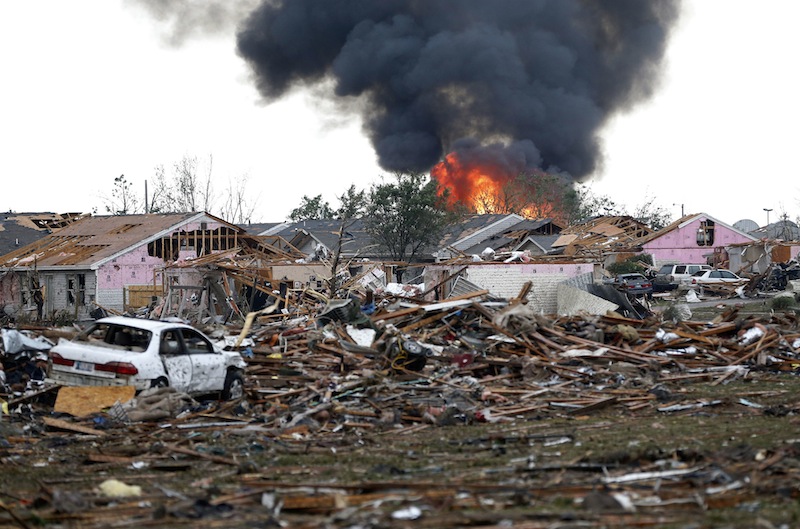 A fire burns in the Tower Plaza Addition in Moore, Okla., following a tornado Monday, May 20, 2013. A tornado as much as a mile wide with winds up to 200 mph roared through the Oklahoma City suburbs Monday, flattening entire neighborhoods, setting buildings on fire and landing a direct blow on an elementary school. (AP Photo Sue Ogrocki)