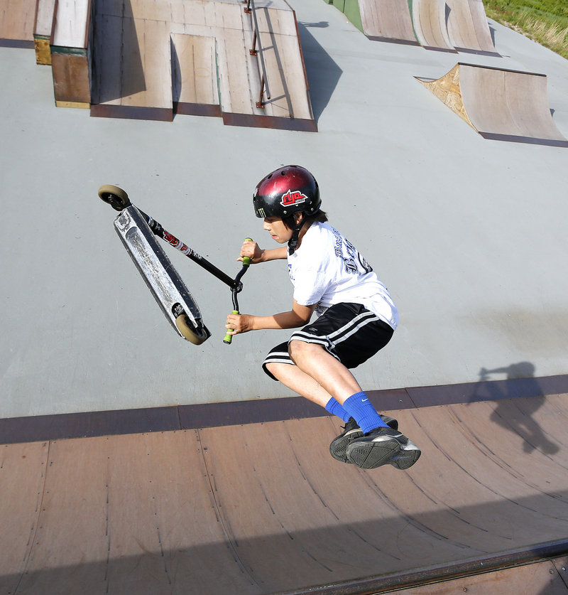 Alex Sappier, 13, of Windham flips his scooter while riding a ramp at Windham Skate Park on Tuesday, May 28, 2013. There will be no supervision at the park, starting July 1. The Town Council decided Tuesday to cut $17,000 to fund staffing at the park.