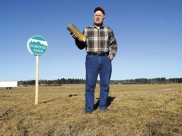Vassalboro farmer Peter Bragdon hopes to preserve farmland by producing logs from hay for home heating use.