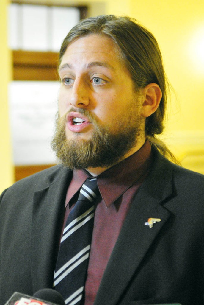 Paul T. McCarrier, legislative liason for the Medical Marijuana Caregivers of Maine, talks to reporters on Friday at the State House in Augusta. He was there to testify against LD 1229, An Act To Regulate and Tax Marijuana.