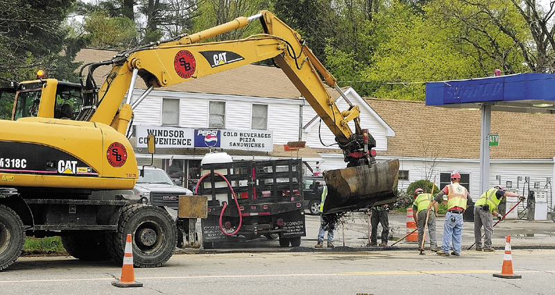 Paving crews work in front of Windsor Convenience covering over a trench where natural gas pipeline was recently laid on edge of Route 17 in Windsor.