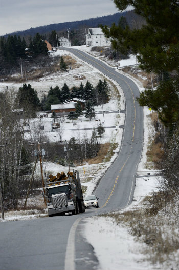 A logging truck heads north on route 11 in St. John Valley just north of Eagle Lake Friday, November 9, 2012. (Press Herald file photo)
