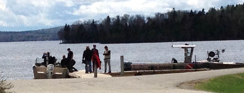 Maine Warden Service divers search Rangeley Lake on Thursday for three snowmobilers missing since winter.