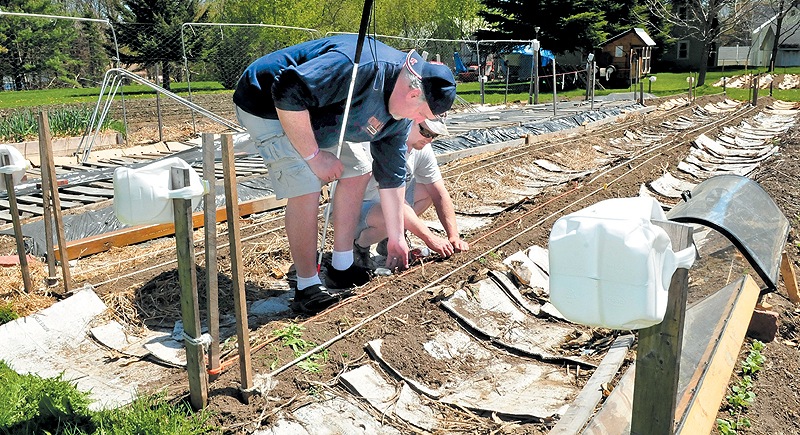 Deon Lyons, left, learns where the rope lines are with help from visually impaired gardener David Perry in Fairfield.