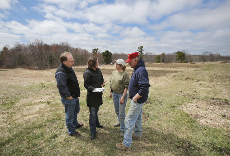 Tod Yankee, left, and Jamien Richardson talk with Kathy and Pete Karonis at the Karonises’ Fairwinds Farm in Topsham. The farmers plan to sell some of their crops to Maine Harvest Co., a new enterprise being started by Richardson and Yankee in the former Navy Commissary in Topsham.