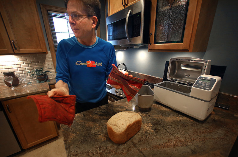 Jeff Grosscup takes a fresh loaf of bread out of his bread-making machine.
